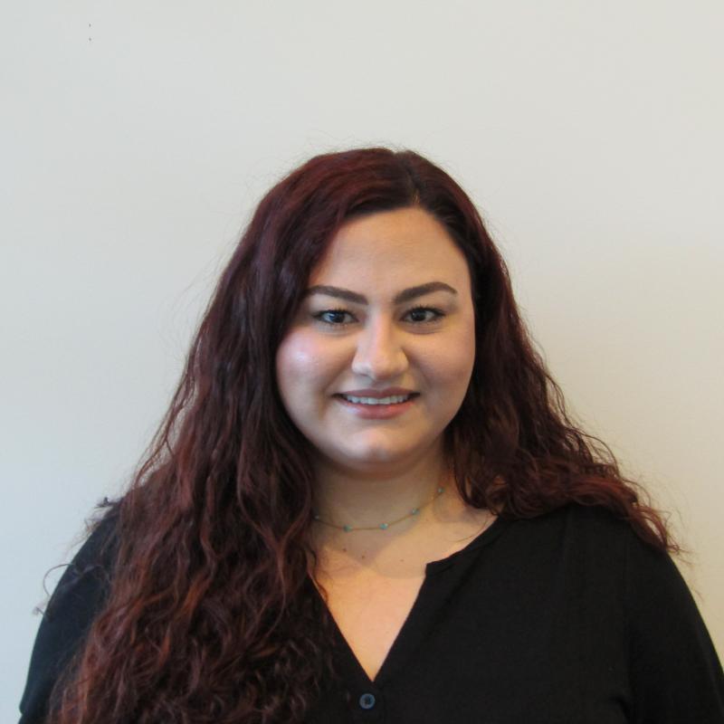 Clinical Coordinator Anita Muradyan wearing a black blouse smiling at the camera